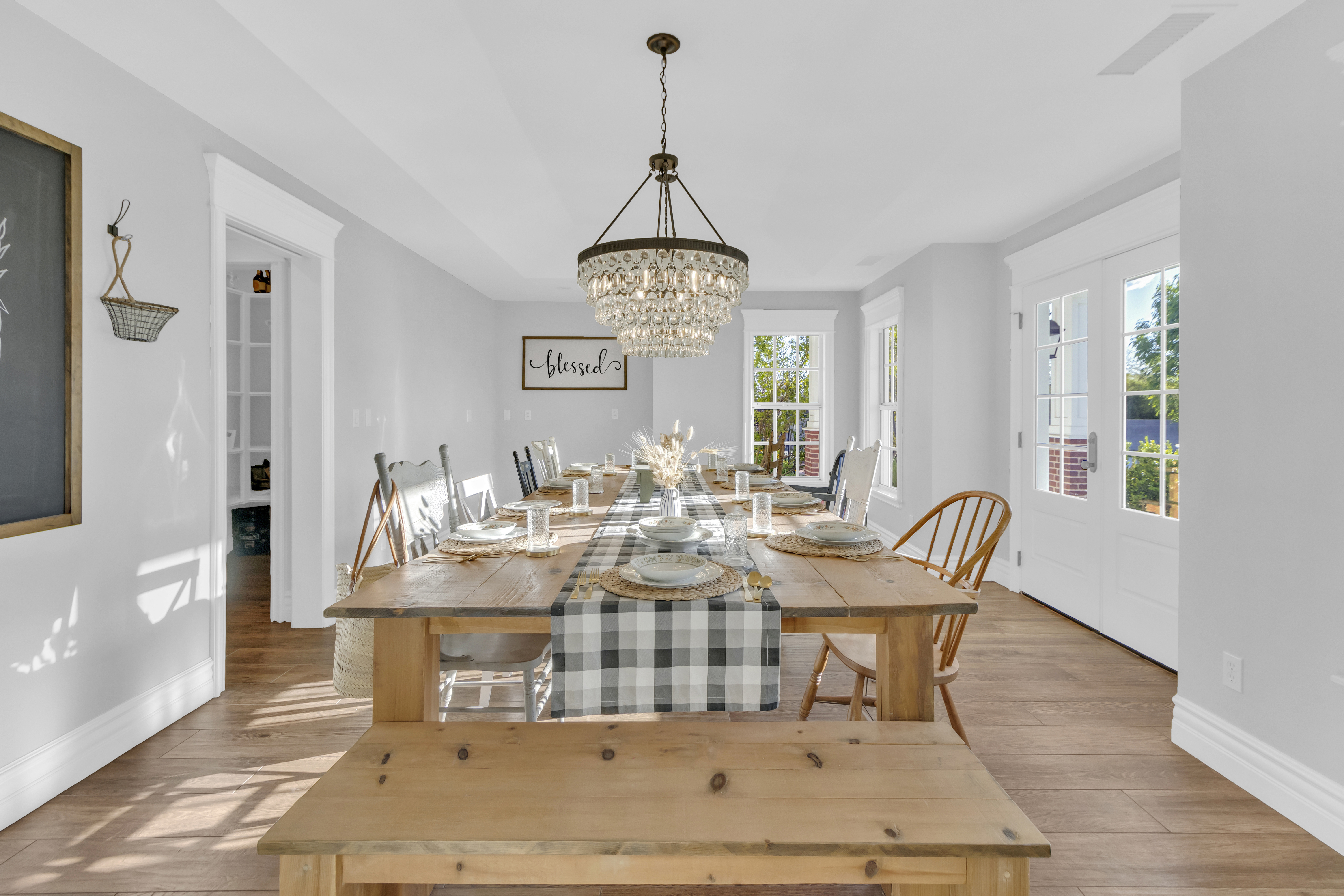 Farmhouse dining room with crystal chandeliers